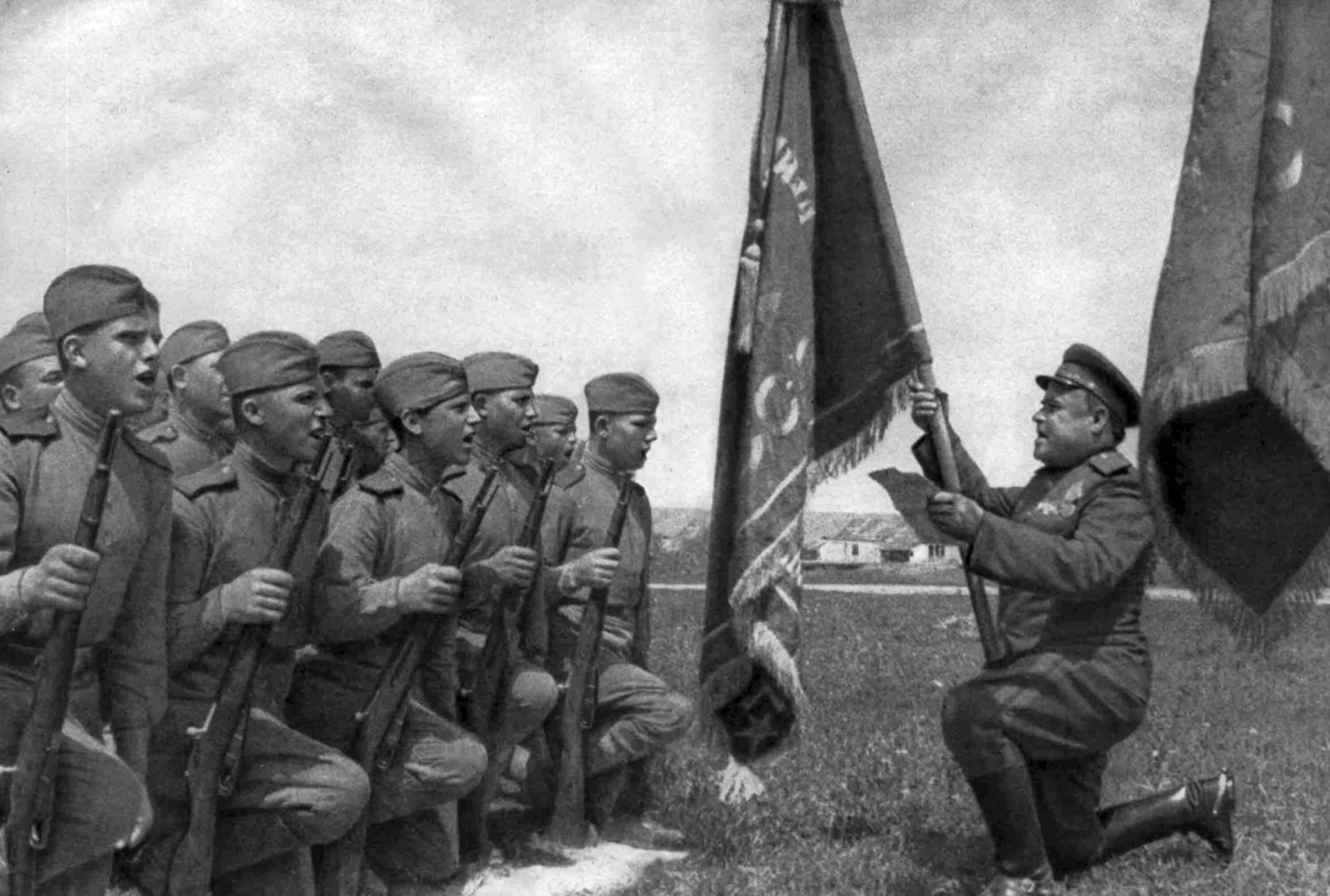 Soviet soldiers take an oath in front of the banner